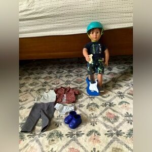 American boy doll with two sets of clothes and accessories.